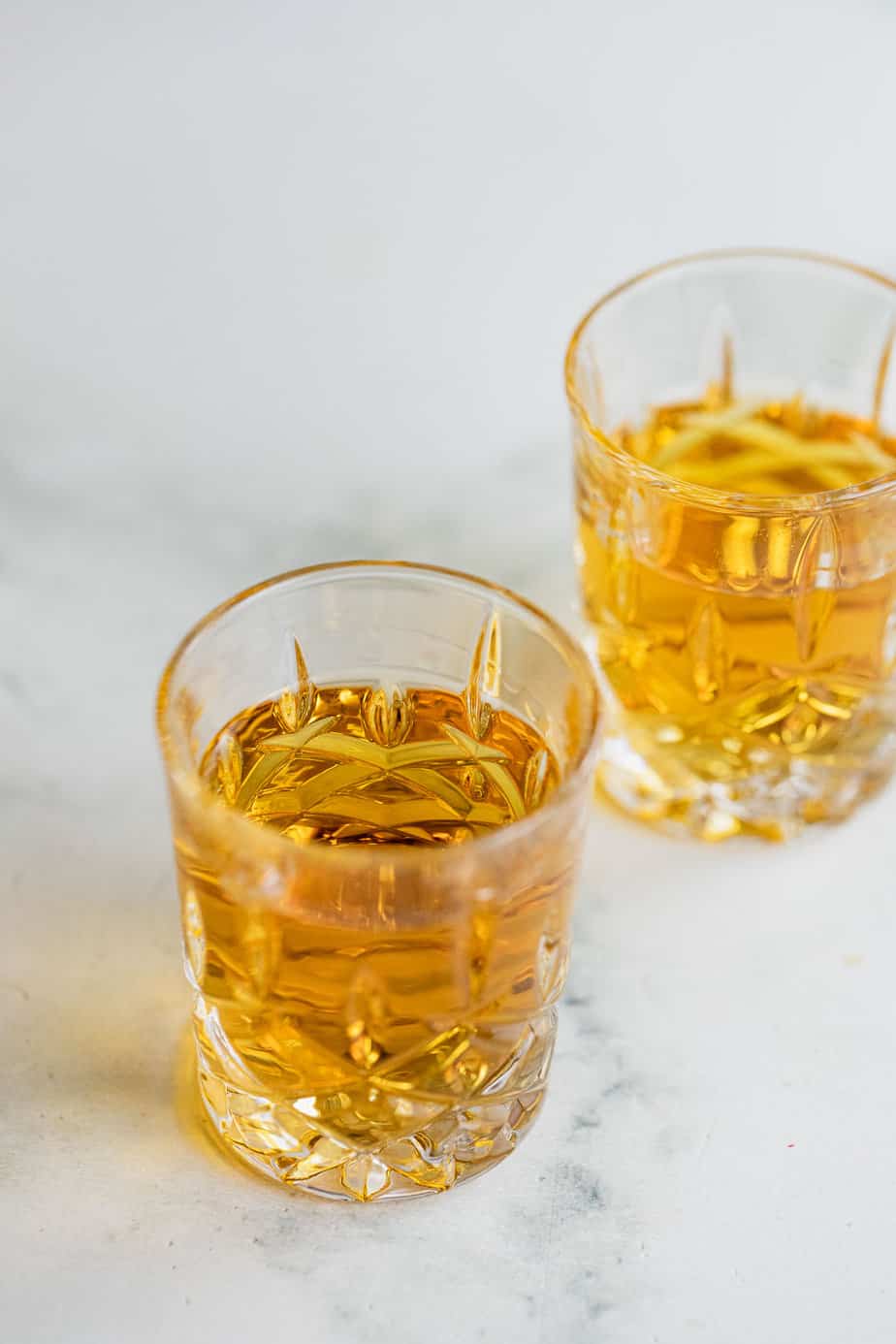 two shots of whiskey on marble background