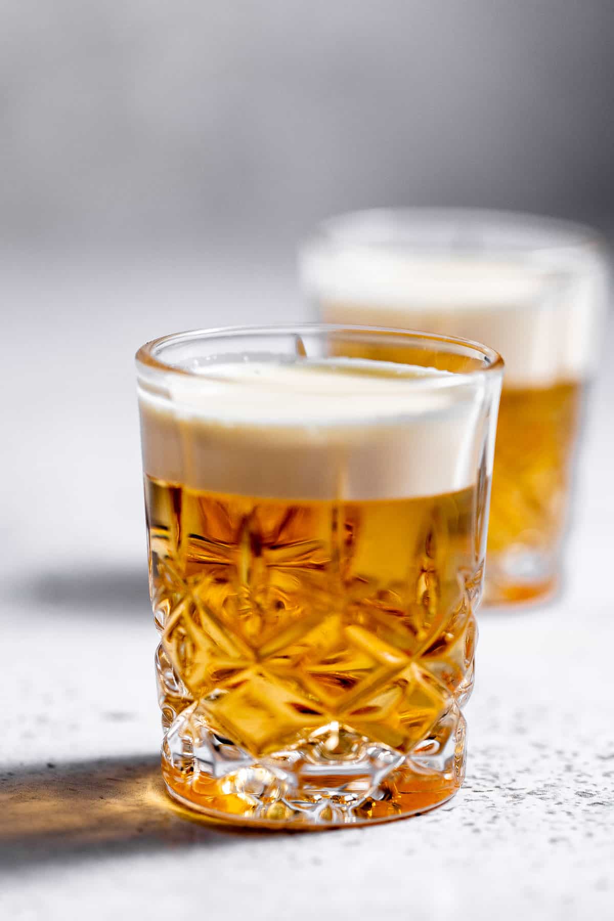 Mini Beer Shots on marble background.