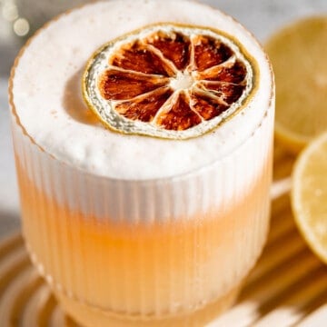 vodka sour topped with dry lemon slice