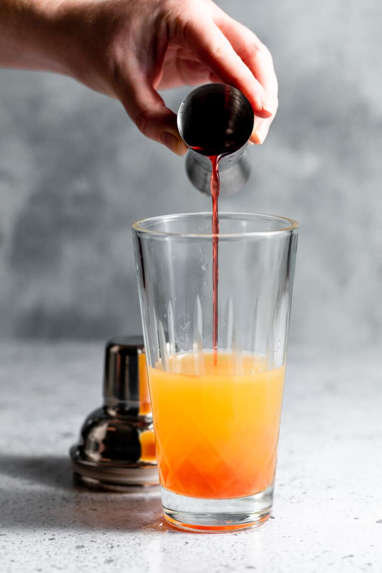adding passoa to cocktail shaker