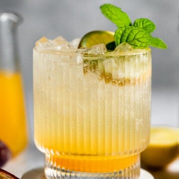deep eddy lemon vodka passionfruit soda in ribbed glass and garnished with fresh mint