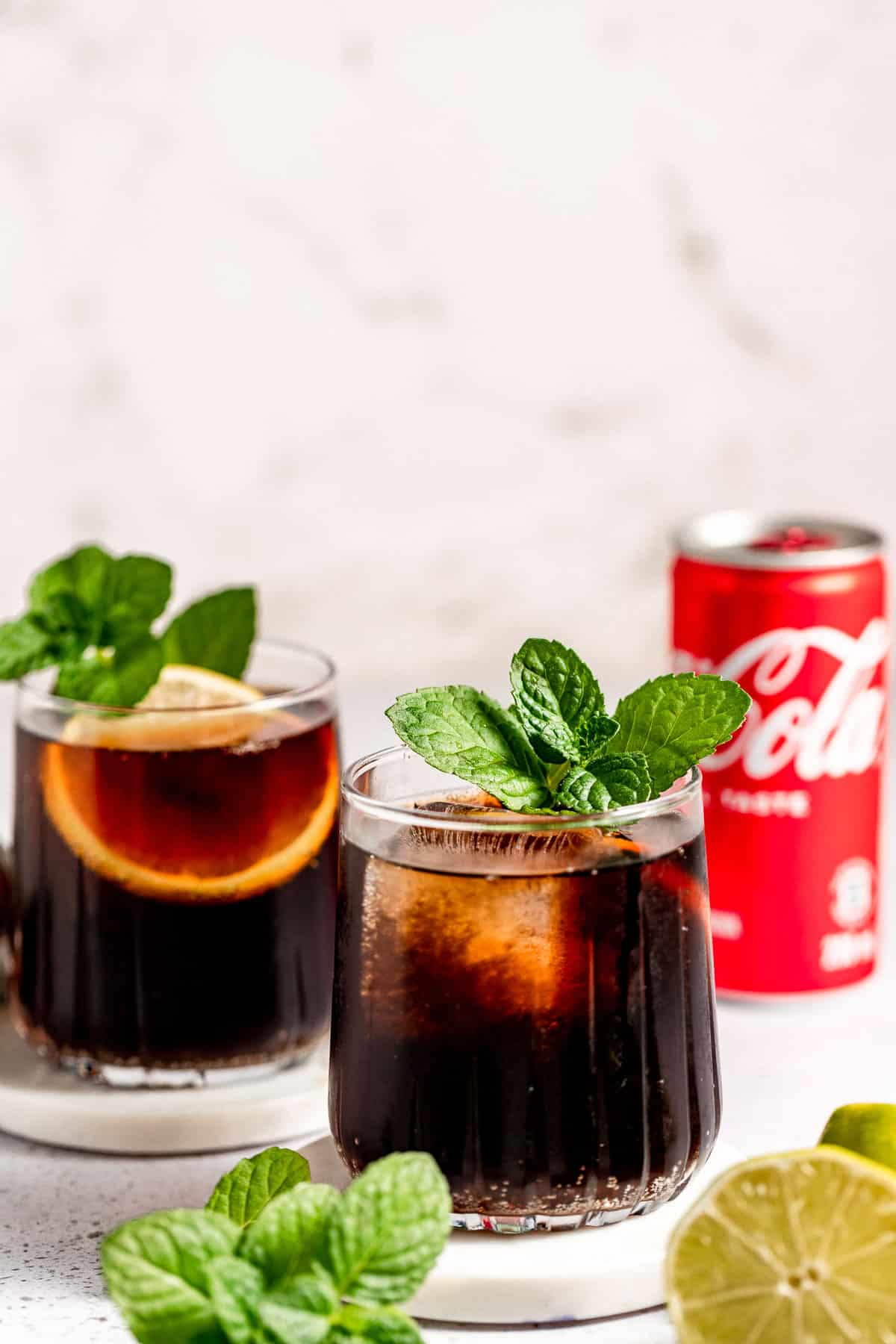 whiskey and coke on marble background with can of coke