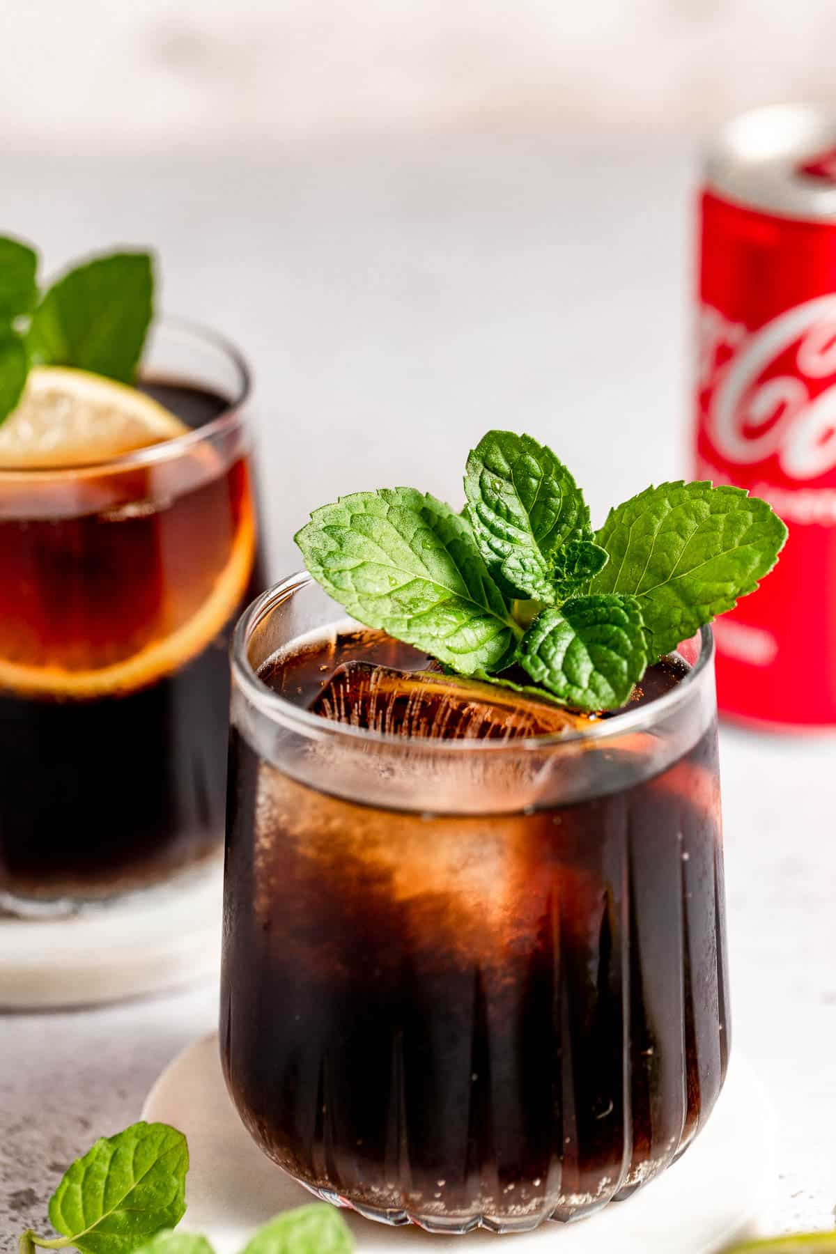 whiskey and coke in tumbler glass with fresh mint