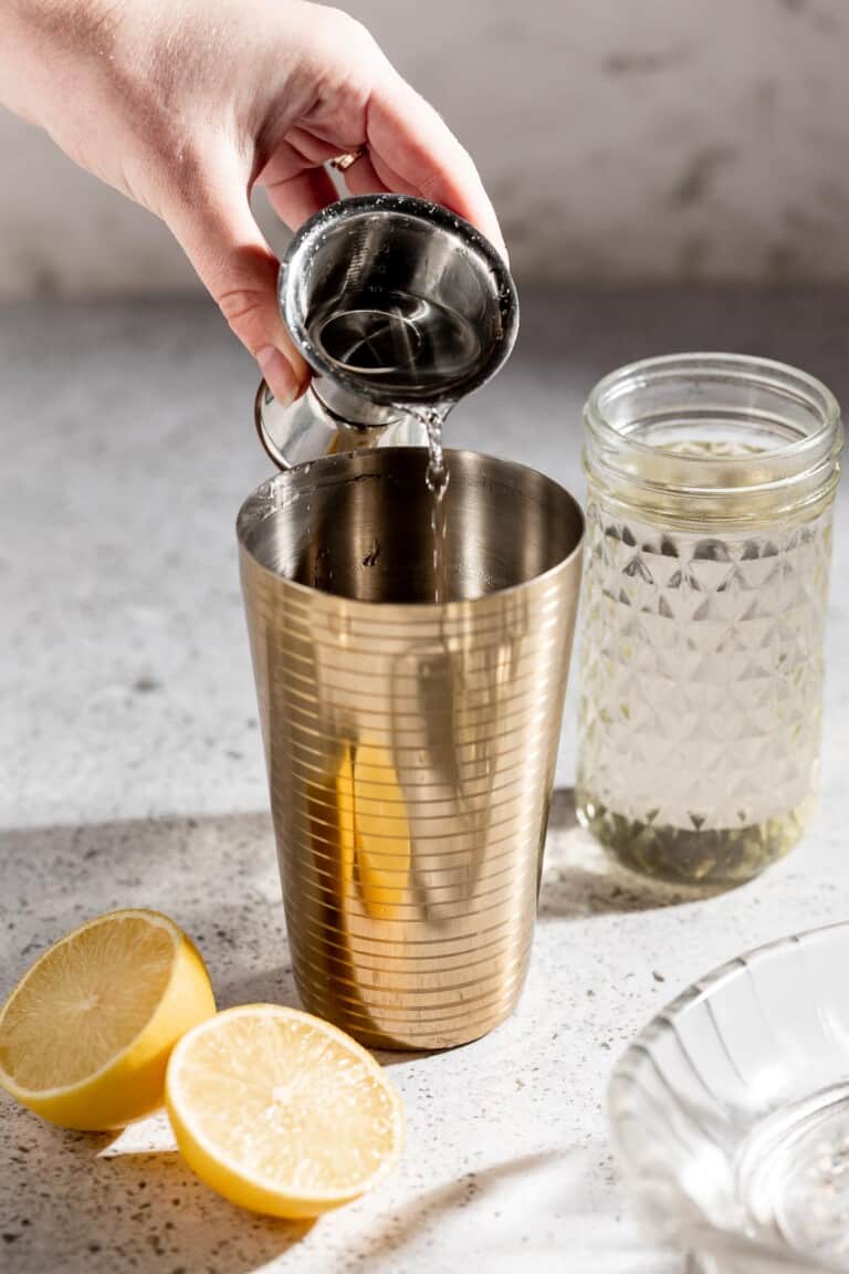 pouring vodka into cocktail shaker