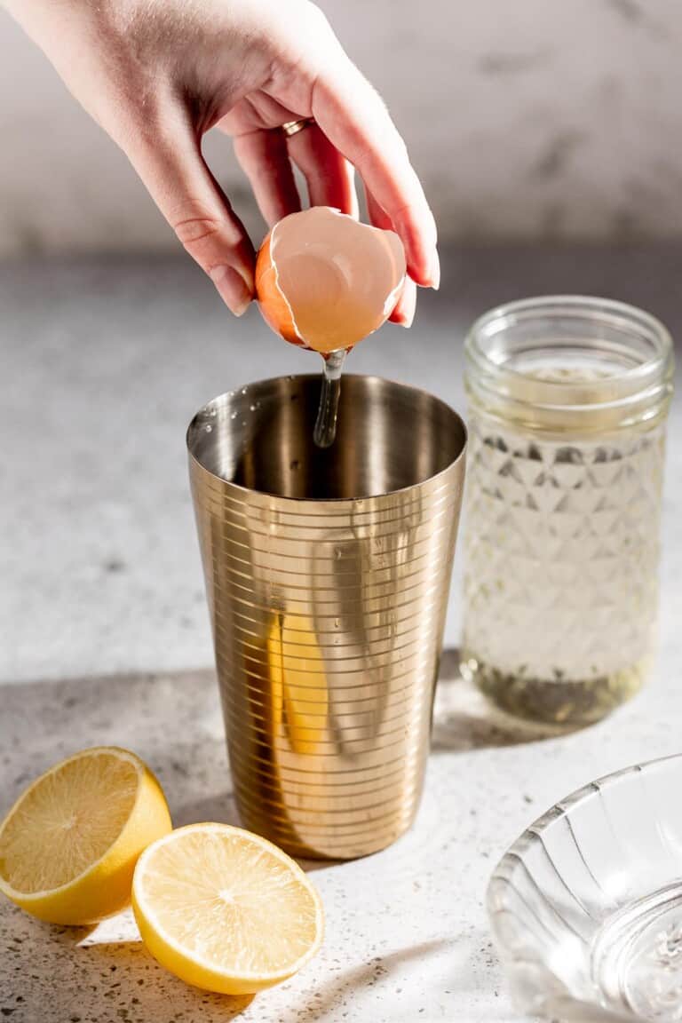 adding egg white to cocktail shaker
