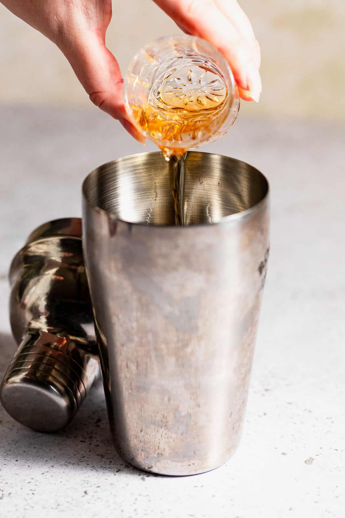 Whiskey pouring into a drink shaker