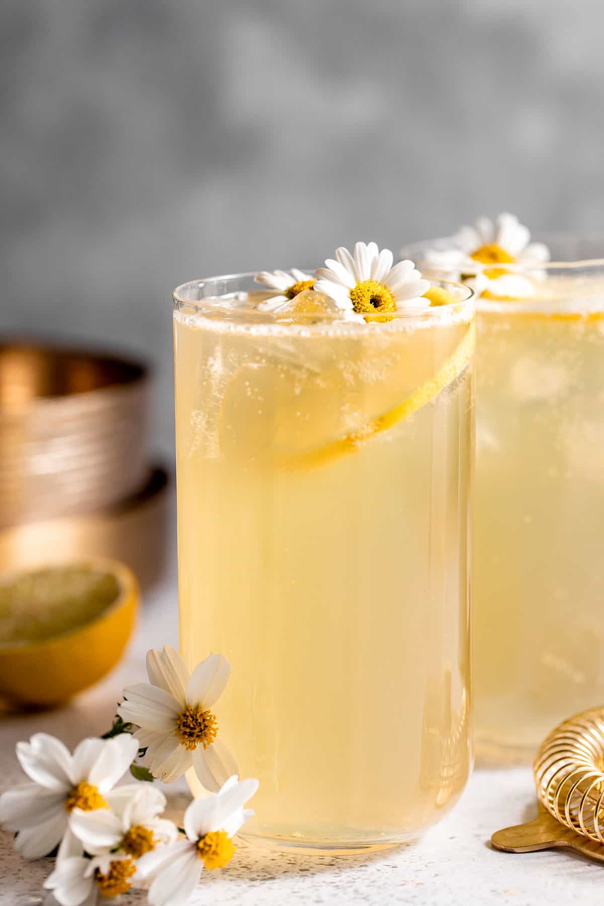 two tall glasses with lemonade and fresh slices of lemon