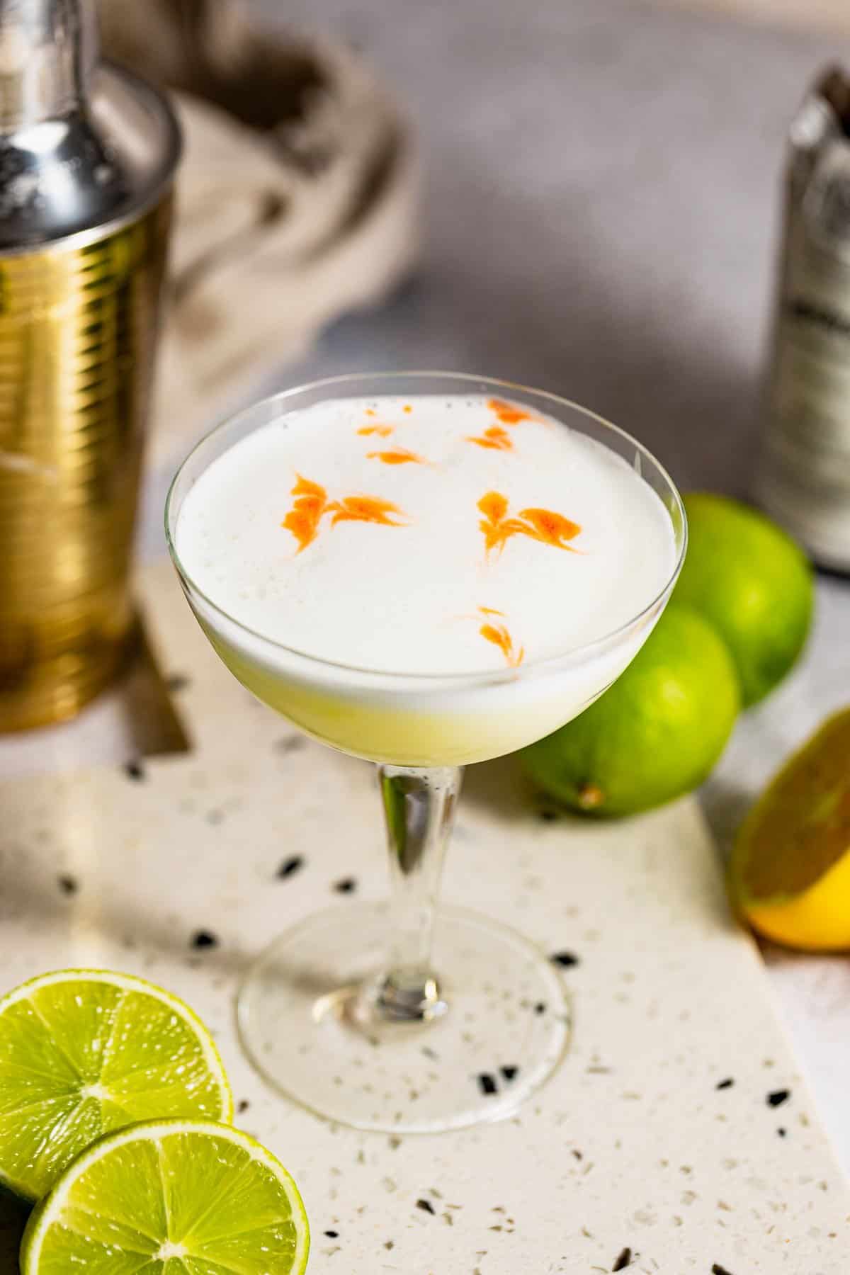 mezcal sour with gold cocktail shaker