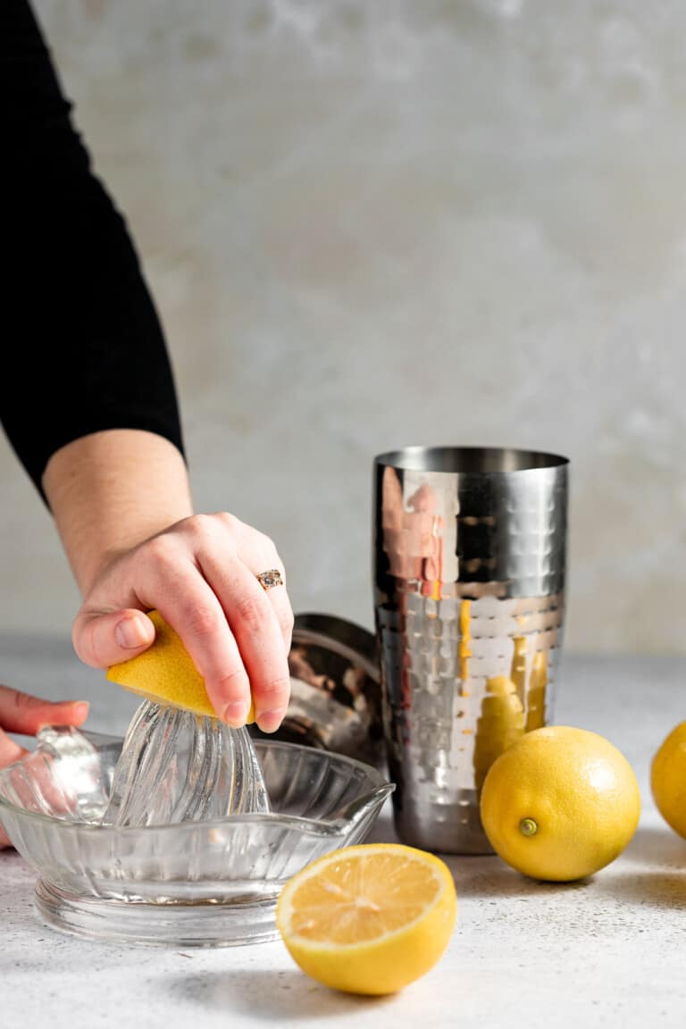 squeezing lemon for cocktail on lemon juicer